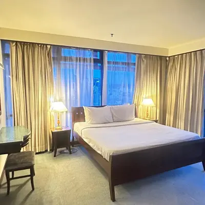 a bedroom with a large bed and a large window at Peak Suites At Times Square in Kuala Lumpur