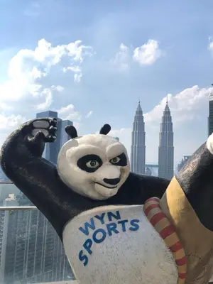 a statue of a panda bear holding a sign at 8 Kia Peng Suites KLCC by Luna in Kuala Lumpur