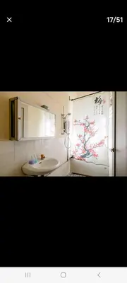 a bathroom with a white sink and a window at Ming Yuan Homestay in Kuala Lumpur