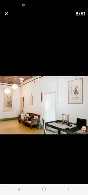 a living room with a table and a couch at Ming Yuan Homestay in Kuala Lumpur