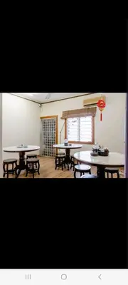 a room with two tables and benches and a window at Ming Yuan Homestay in Kuala Lumpur