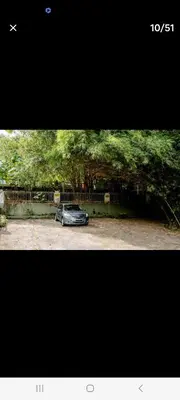 a car parked in a parking lot next to a wall at Ming Yuan Homestay in Kuala Lumpur