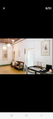 a living room with a table and a couch at Ming Yuan Homestay in Kuala Lumpur