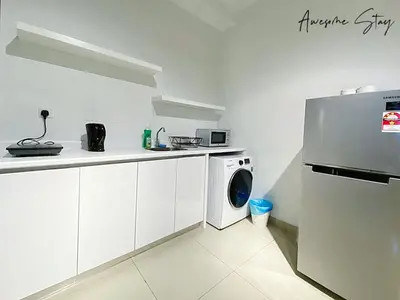 a kitchen with a refrigerator and a washing machine at Arte Plus Ampang in Kuala Lumpur