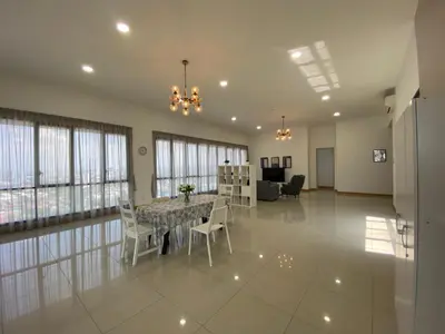 a large living room with a table and chairs at KL Gateway Penthouse by Cobnb - 10Pax in Kuala Lumpur