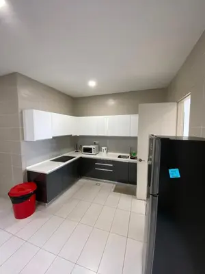 a kitchen with a black refrigerator and a white tile floor at KL Gateway Penthouse by Cobnb - 10Pax in Kuala Lumpur