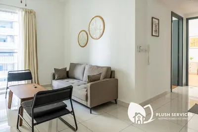 a living room with a couch and a table at Inspirasi@Mont Kiara in Kuala Lumpur