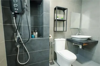 a bathroom with a shower and a toilet and a sink at Inspirasi@Mont Kiara in Kuala Lumpur