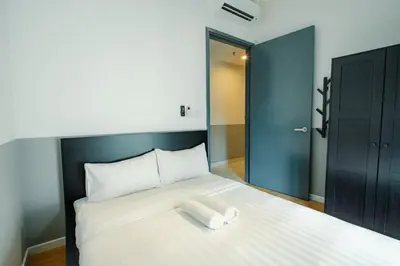 a bedroom with a bed with two towels on it at Inspirasi@Mont Kiara in Kuala Lumpur