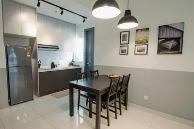 a kitchen with a table and chairs and a refrigerator at Inspirasi@Mont Kiara in Kuala Lumpur