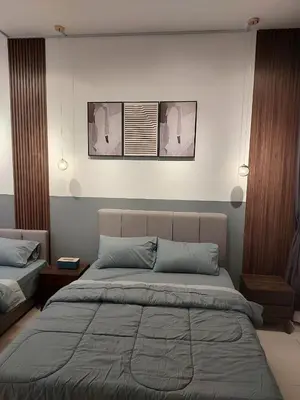 a bedroom with a large bed with two pictures on the wall at Chambers Platinum Suite Kuala Lumpur in Kuala Lumpur