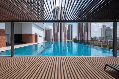 a large swimming pool with a view of a city at Chambers Platinum Suite Kuala Lumpur in Kuala Lumpur