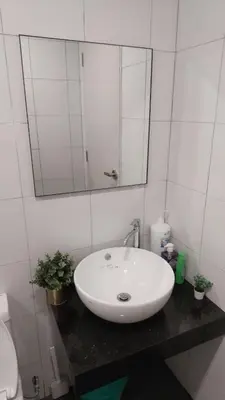 a bathroom with a white sink and a mirror at Chambers Platinum Suite Kuala Lumpur in Kuala Lumpur