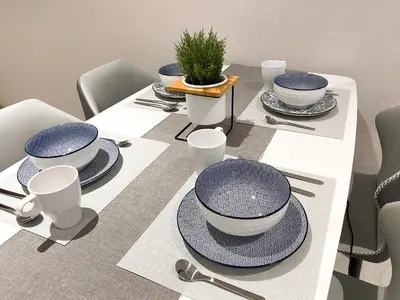 a table with blue and white dishes on it at Quill Residences Suite by Mimpi B&B in Kuala Lumpur