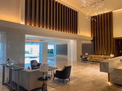 a lobby of a hotel with chairs and tables at Quill Residences Suite by Mimpi B&B in Kuala Lumpur