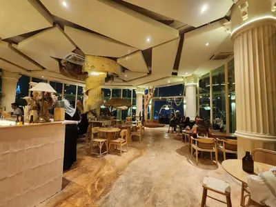 a restaurant with a bar and people sitting at tables at Regalia Suites Kuala Lumpur KLCC in Kuala Lumpur