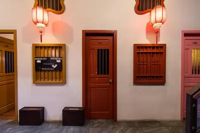 a wall with three doors and lights on it at Travel Hub Highstreet in Kuala Lumpur
