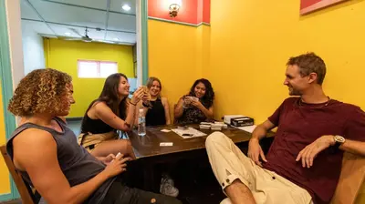 a group of people sitting around a table in a room at Travel Hub Highstreet in Kuala Lumpur