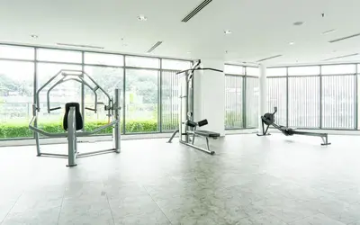 a gym with cardio equipment and large windows at VIVO at 9 Seputeh by Airhost in Kuala Lumpur