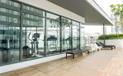 a large building with glass windows and a patio at VIVO at 9 Seputeh by Airhost in Kuala Lumpur