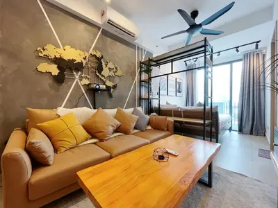 a living room with a couch and a table at Colony By Infinitum in Kuala Lumpur