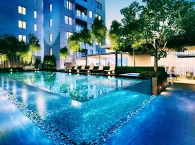 a swimming pool in front of a building at Mercu Summer Suites Klcc by Luxe Residence in Kuala Lumpur
