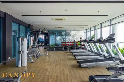 a gym with a row of treadmills and machines at The Luxe & The Colony, KLCC in Kuala Lumpur