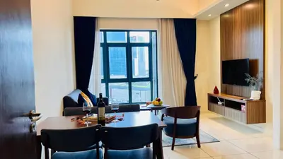 a living room with a table and chairs and a television at Suites TribecaTRX Kuala Lumpur by ZenGlo 5min walk to The Exchange TRX in Kuala Lumpur
