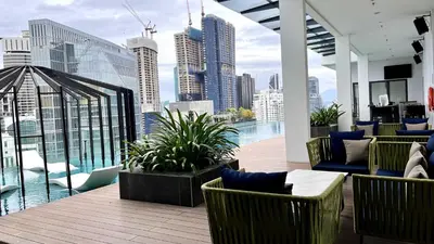 a balcony with chairs and a view of a city at Suites TribecaTRX Kuala Lumpur by ZenGlo 5min walk to The Exchange TRX in Kuala Lumpur