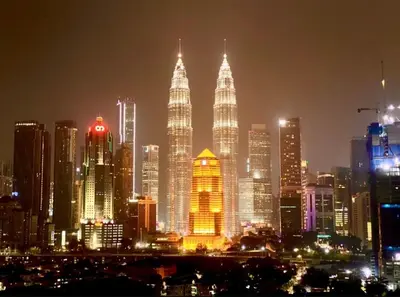 a lit up city skyline at night with tall buildings at Nour Homestay KLCC View - COZY 2 in Kuala Lumpur