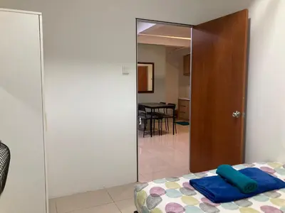 a bedroom with a door leading to a dining room at Nour Homestay KLCC View - COZY 2 in Kuala Lumpur