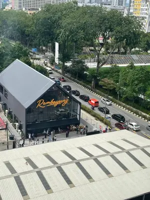 a building with a sign on it next to a street at Nour Homestay KLCC View - COZY 2 in Kuala Lumpur