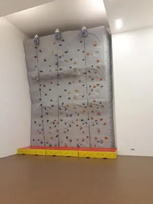 a climbing wall in a room with a rock wall at M City with Pool KLCC city view in Kuala Lumpur