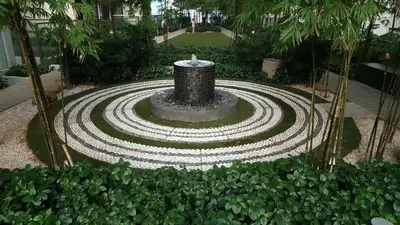 a fountain in the middle of a garden at M City with Pool KLCC city view in Kuala Lumpur