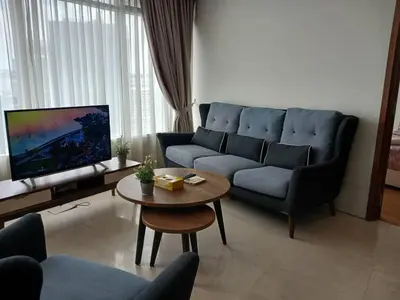 a living room with a blue couch and a table at VORTEX STAR KLCc APARTMENT in Kuala Lumpur