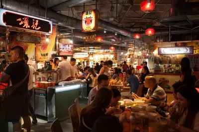 a group of people eating at a restaurant at Gold3 Boutique Hotel in Kuala Lumpur