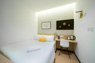 a small bedroom with a bed and a desk at Gold3 Boutique Hotel in Kuala Lumpur