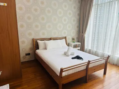 a bedroom with a bed with a hat on it at Soho Suites KLCC by Angel in Kuala Lumpur
