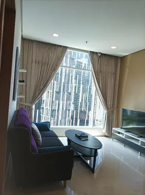 a living room with a couch and a large window at Soho Suites KLCC by Angel in Kuala Lumpur