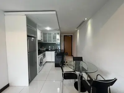 a kitchen with a glass table and black chairs at BBHomes at Casa Residency KL in Kuala Lumpur