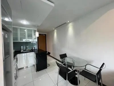 a kitchen with a glass table and black chairs at BBHomes at Casa Residency KL in Kuala Lumpur