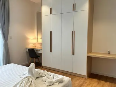 a bedroom with white cabinets and a desk at Quill Suites KLCC in Kuala Lumpur