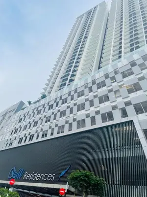 a tall building with a sign in front of it at Quill Suites KLCC in Kuala Lumpur