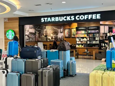 a bunch of suitcases in a starbucks coffee store at Quill Suites KLCC in Kuala Lumpur