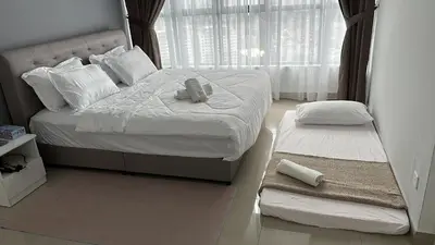 a bedroom with a bed with a stuffed animal on it at family suite Laville#velocity maluri by Homeizing in Kuala Lumpur