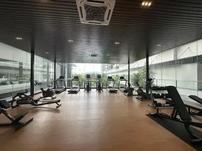 a gym with a lot of treadmills and exercise bikes at family suite Laville#velocity maluri by Homeizing in Kuala Lumpur