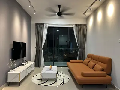 a living room with a couch and a television at family suite Laville#velocity maluri by Homeizing in Kuala Lumpur