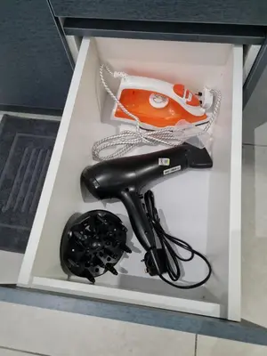 a black hair dryer in a white box at Blue Small Studio Near KLCC in Kuala Lumpur