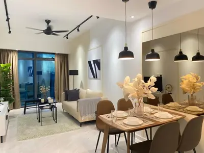 a living room with a dining table and a couch at Eaton Suites KLCC Kuala Lumpur in Kuala Lumpur