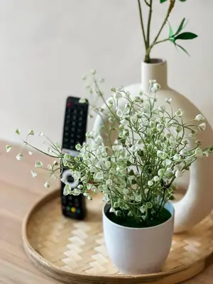 a table with two vases and flowers on it at Riveria City KL Sentral by Sky Pool Minshuku in Kuala Lumpur